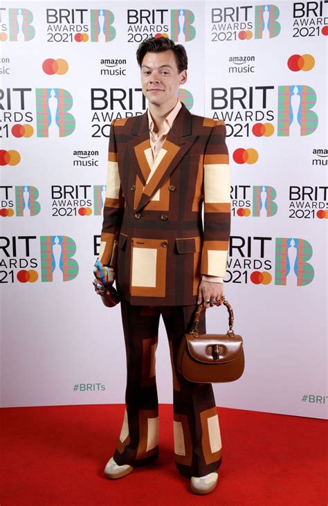 Harry Styles rocks retro suit and handbag at 2021 Brit 